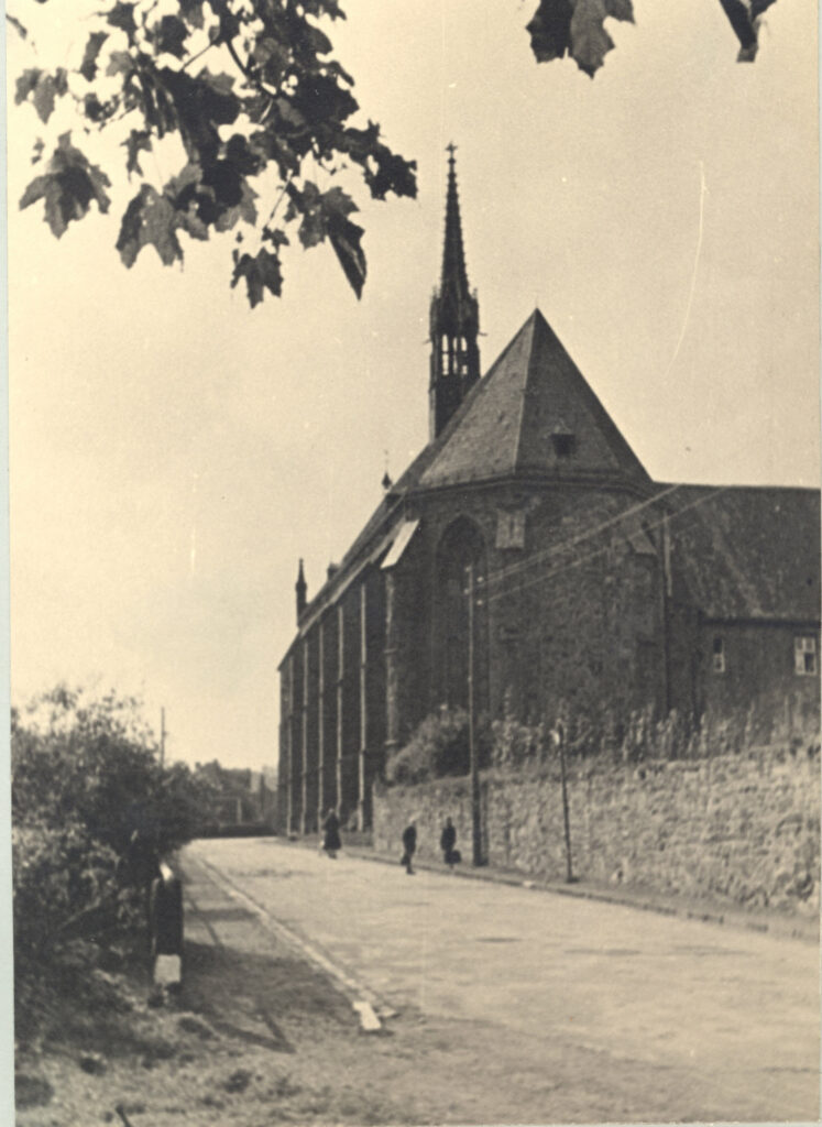zicht op de straat en de kerk, gezien vanaf de absis